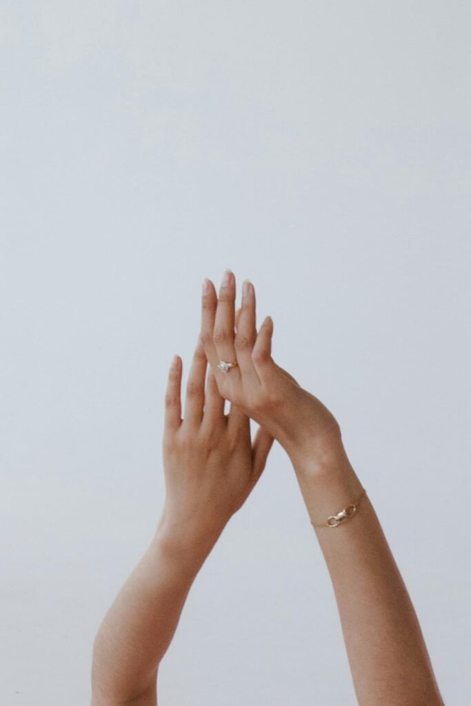 Elegant close-up of a hand with a soft, radiant beam of light shining through, symbolizing inner light and serenity.